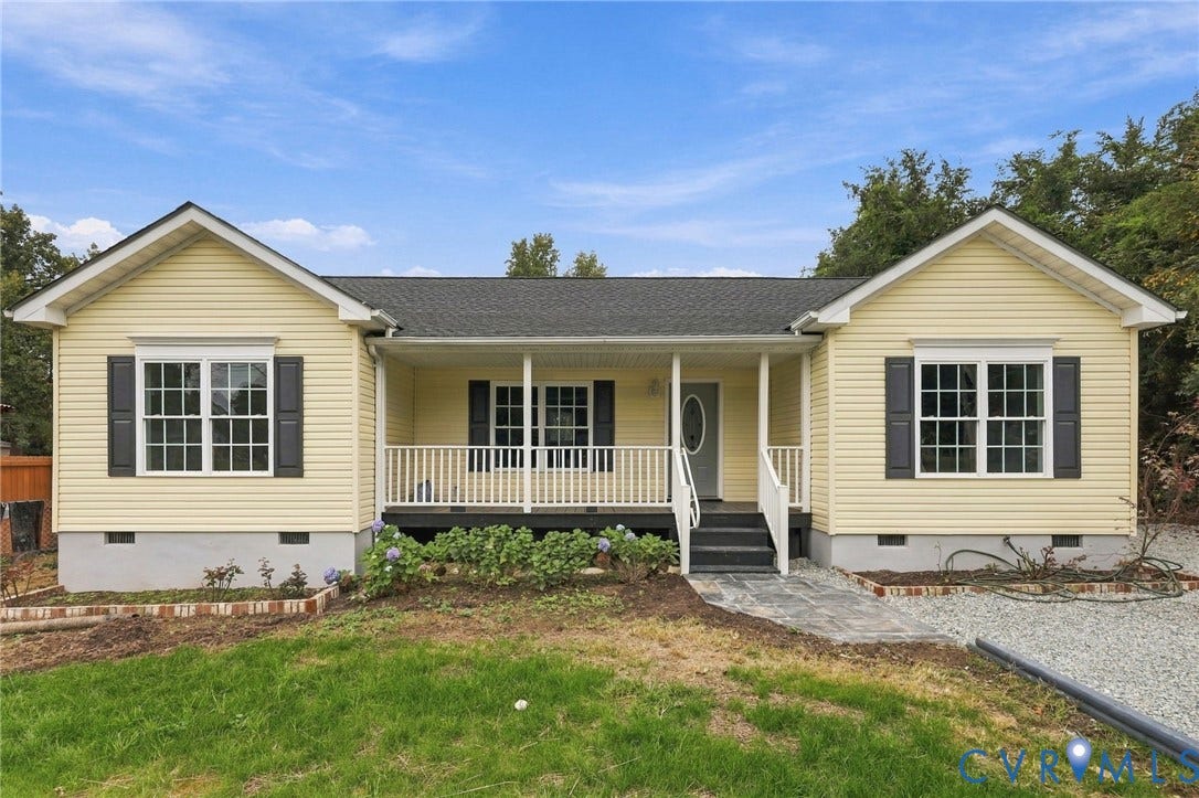 6409 Walmsley Boulevard, Chesterfield, VA 23224 Single-story residence featuring pale yellow horizontal siding, a covered front porch with white railing, contrasting dark shutters, and a grey shingle roof