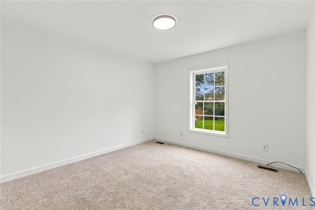 6409 Walmsley Boulevard, Chesterfield, VA 23224 Neutral wall-to-wall carpeting, crisp white wall finishes, single-pane window with grid detailing, and recessed circular ceiling lighting