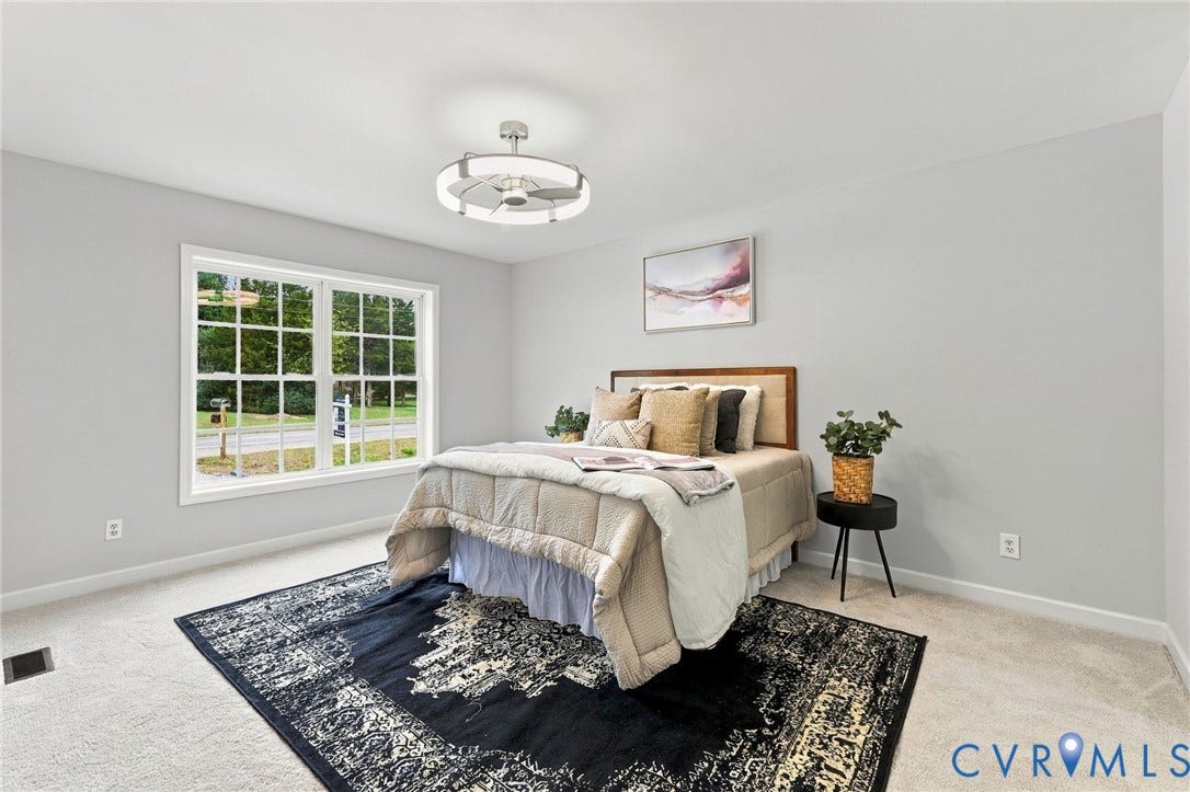 6409 Walmsley Boulevard, Chesterfield, VA 23224 Room interior featuring wall-to-wall carpeting, a large grid-pane window, and a modern circular LED ceiling fixture