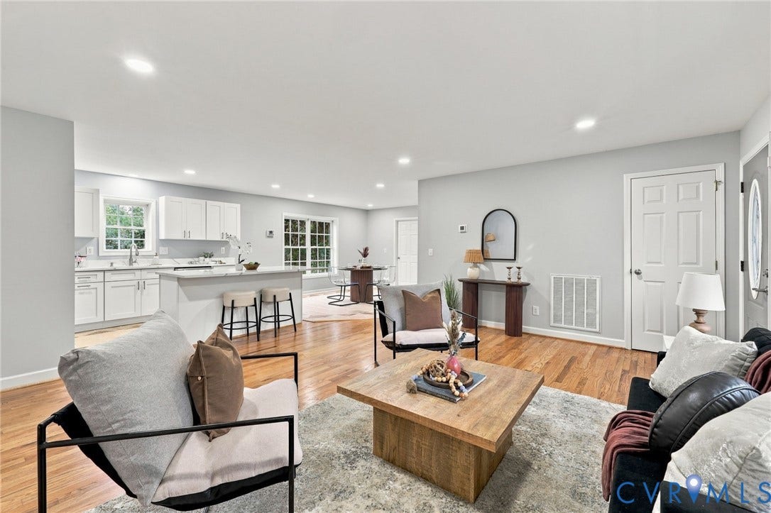 6409 Walmsley Boulevard, Chesterfield, VA 23224 Open-concept floor plan featuring wood-finish flooring, recessed lighting, white cabinetry, and an eat-in kitchen island
