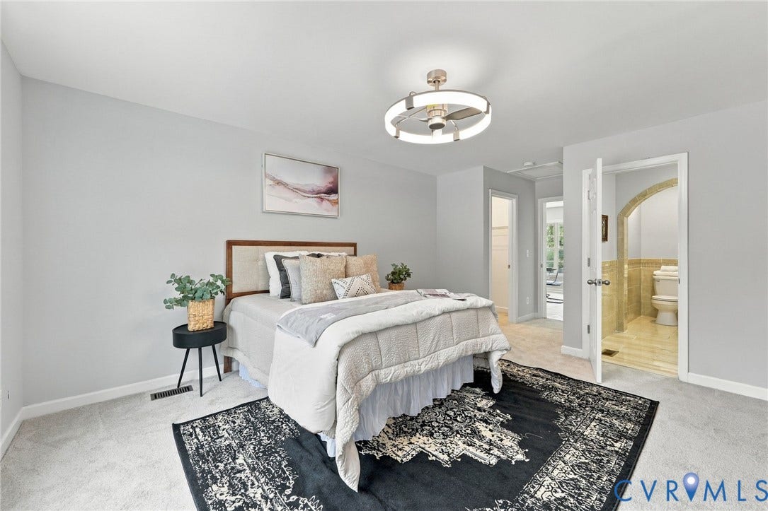 6409 Walmsley Boulevard, Chesterfield, VA 23224 Neutral-toned room featuring a contemporary ceiling fan with integrated circular lighting and tile flooring within the attached bathroom accented by an arched doorway