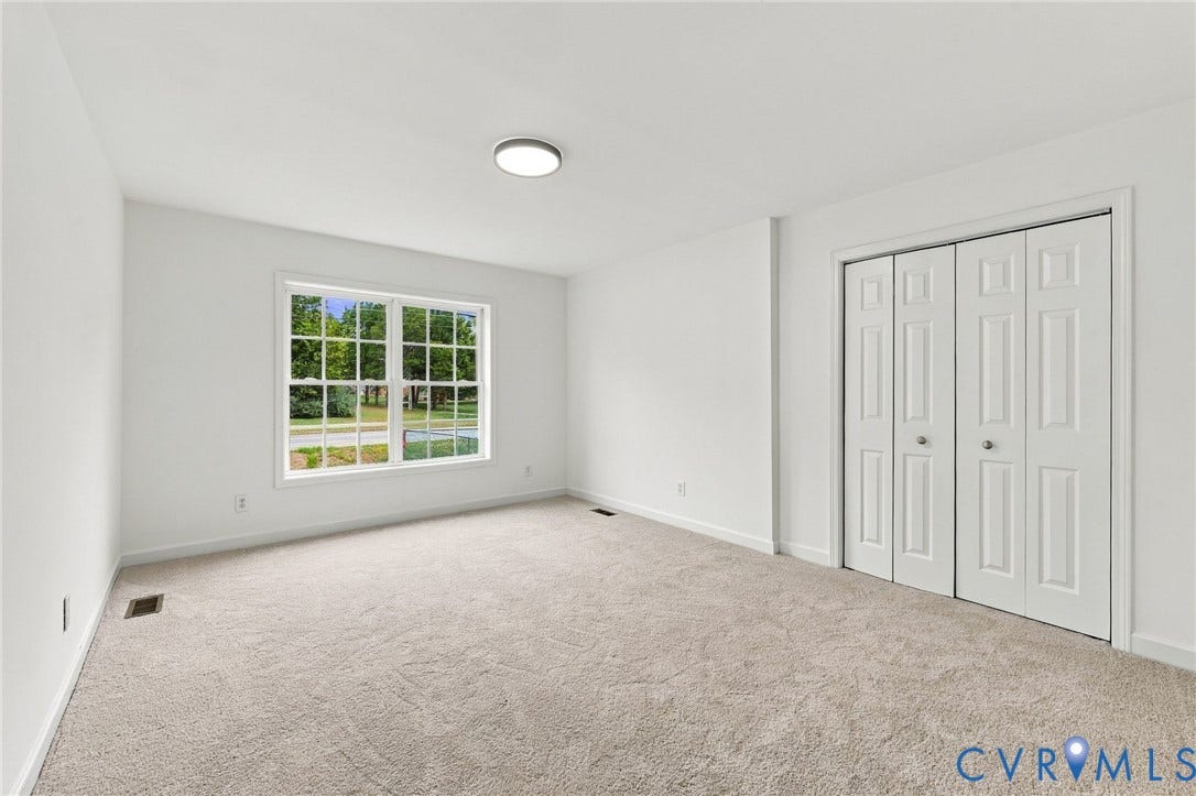 6409 Walmsley Boulevard, Chesterfield, VA 23224 Neutral-toned carpeting, crisp white walls, large grid-pane window, and four-panel bi-fold closet doors