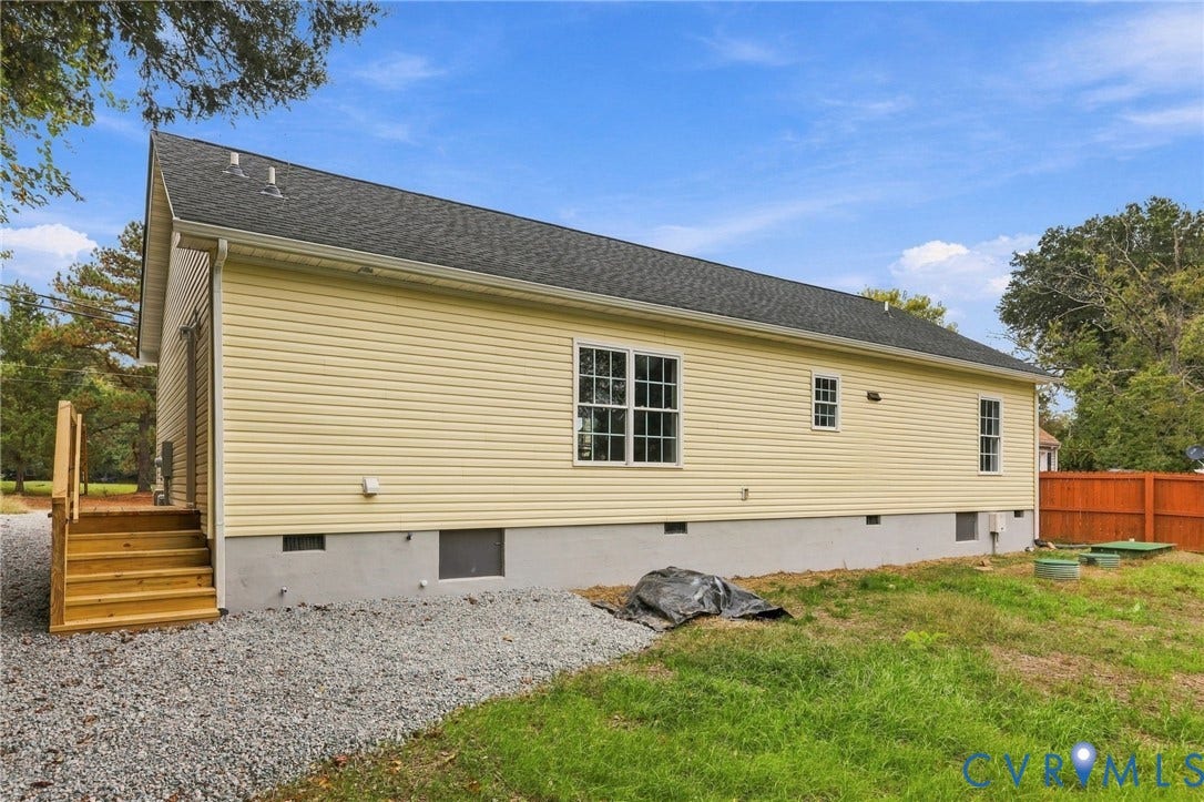 6409 Walmsley Boulevard, Chesterfield, VA 23224 Exterior featuring yellow vinyl siding, a gabled roof, a concrete foundation, and wooden staircase access