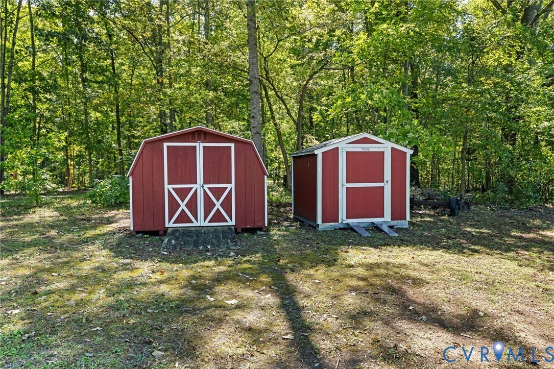 Two red storage sheds with white trim.
