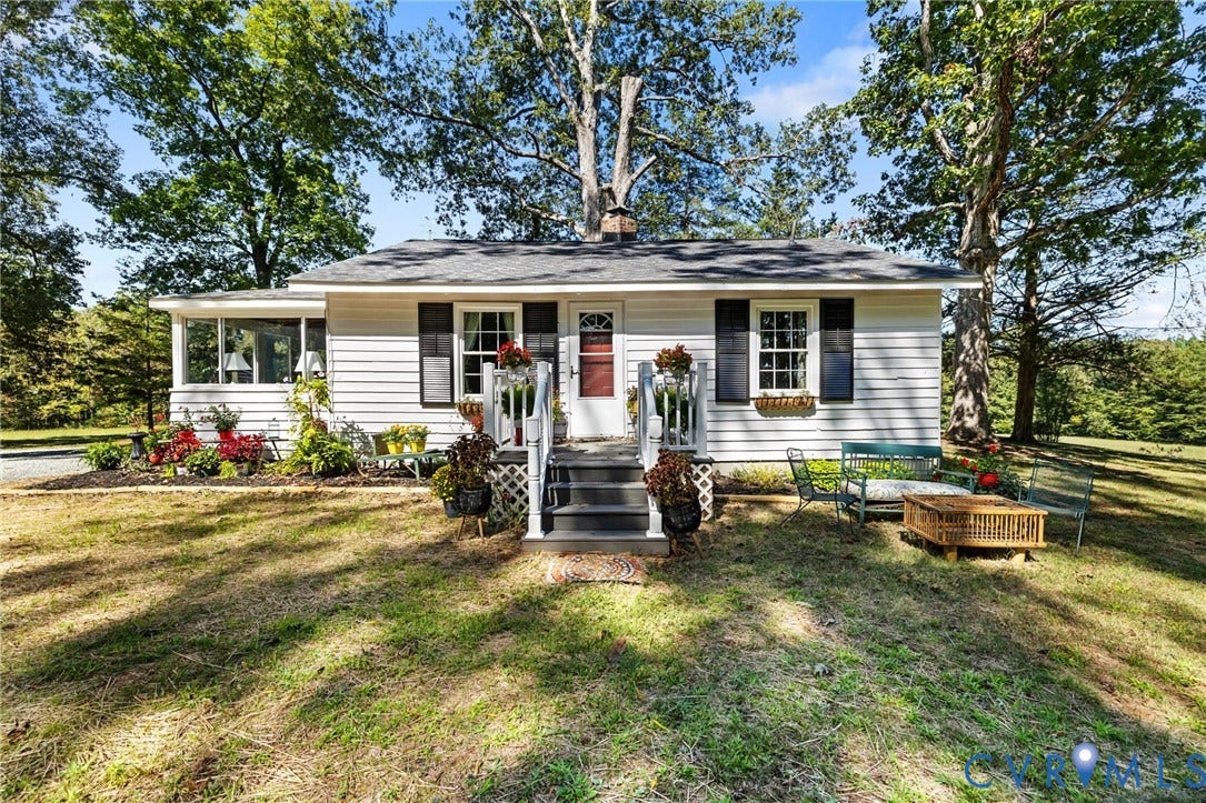 White siding exterior with black window shutters.