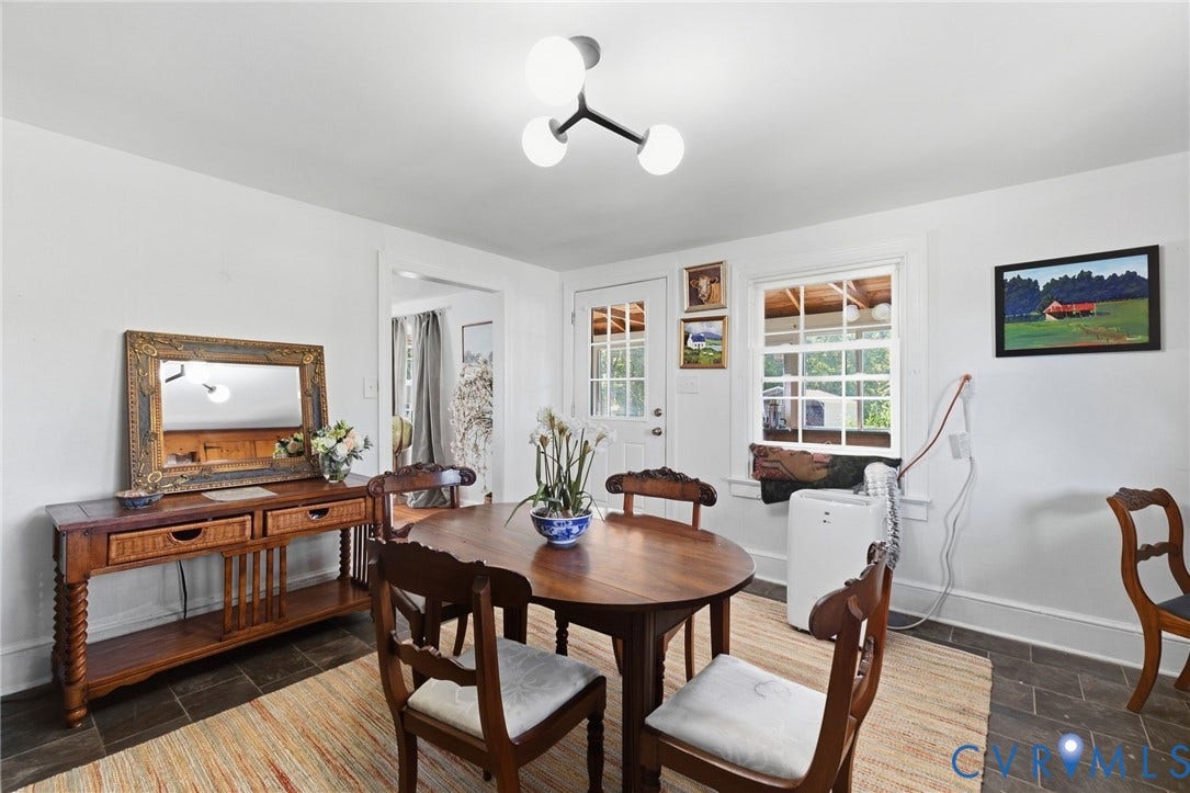 White wall finishes, dark tile flooring, and a contemporary ceiling light fixture.