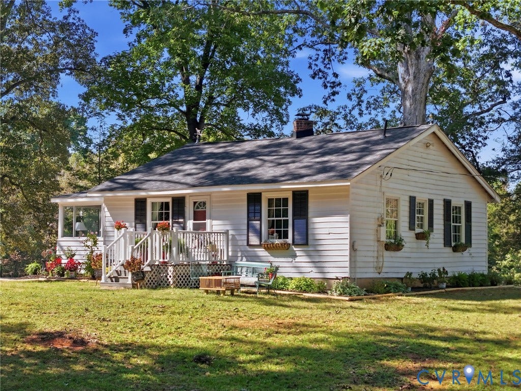 White siding exterior with a dark shingle roof.