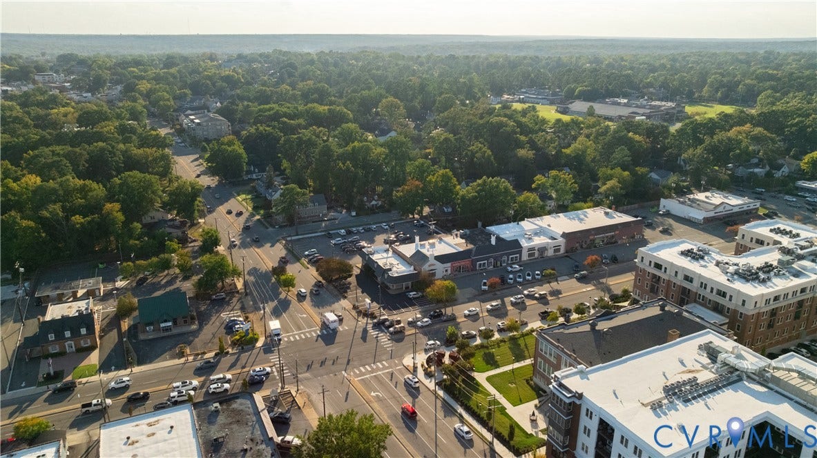 5312 Marian Street, Richmond, VA 23226 Aerial perspective of a mixed-use commercial district with structured parking and adjacent residential buildings