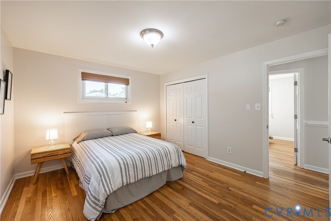 5312 Marian Street, Richmond, VA 23226 Hardwood flooring, double-door closet, single window with blinds, overhead flush mount light fixture, and neutral wall paint