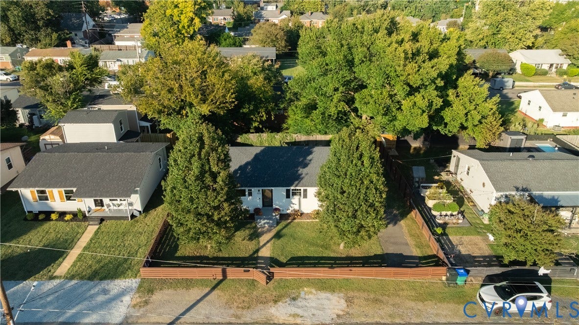 5312 Marian Street, Richmond, VA 23226 Single-story residence with a dark shingle roof, established trees, and a fenced front yard