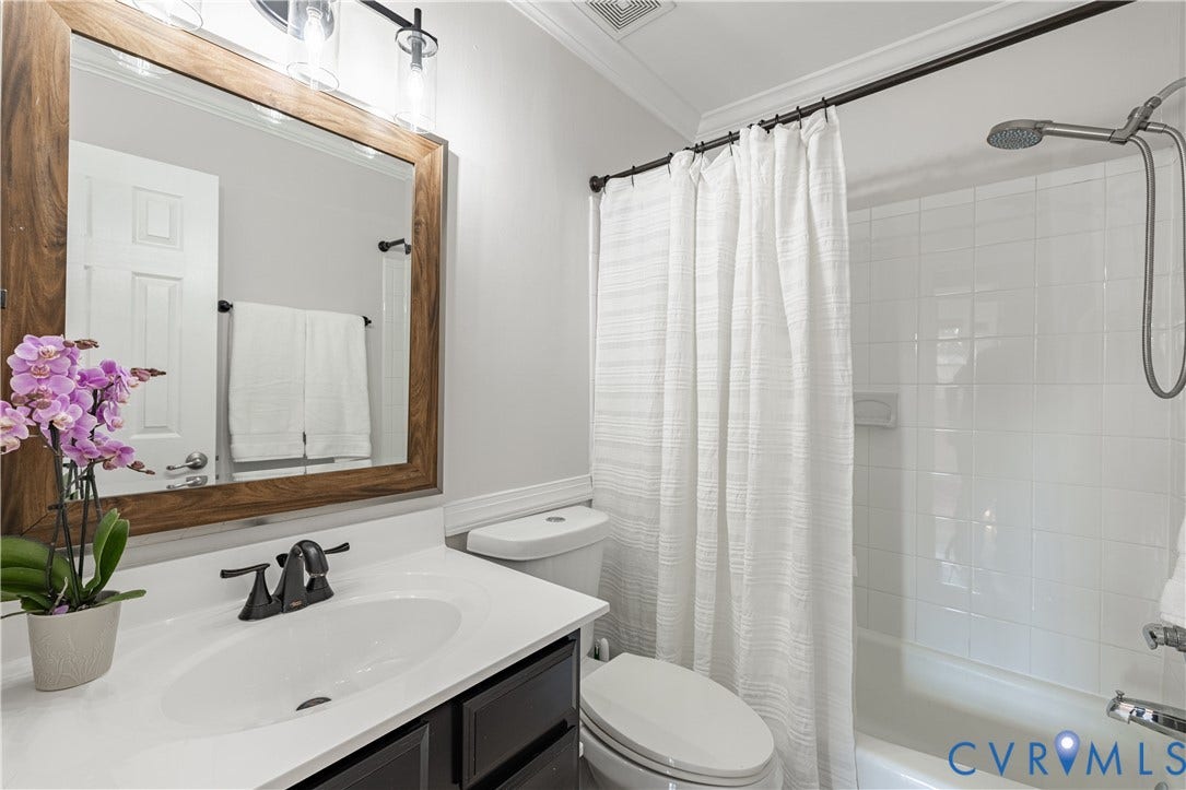 5312 Marian Street, Richmond, VA 23226 White vanity with dark cabinet storage, black faucet, and rectangular undermount sink