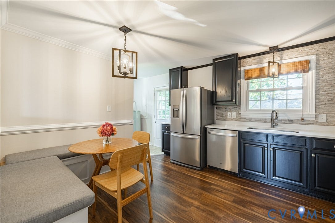 5312 Marian Street, Richmond, VA 23226 Kitchen featuring dark wood-finish cabinetry, stainless steel appliances, a white countertop, and a textured backsplash