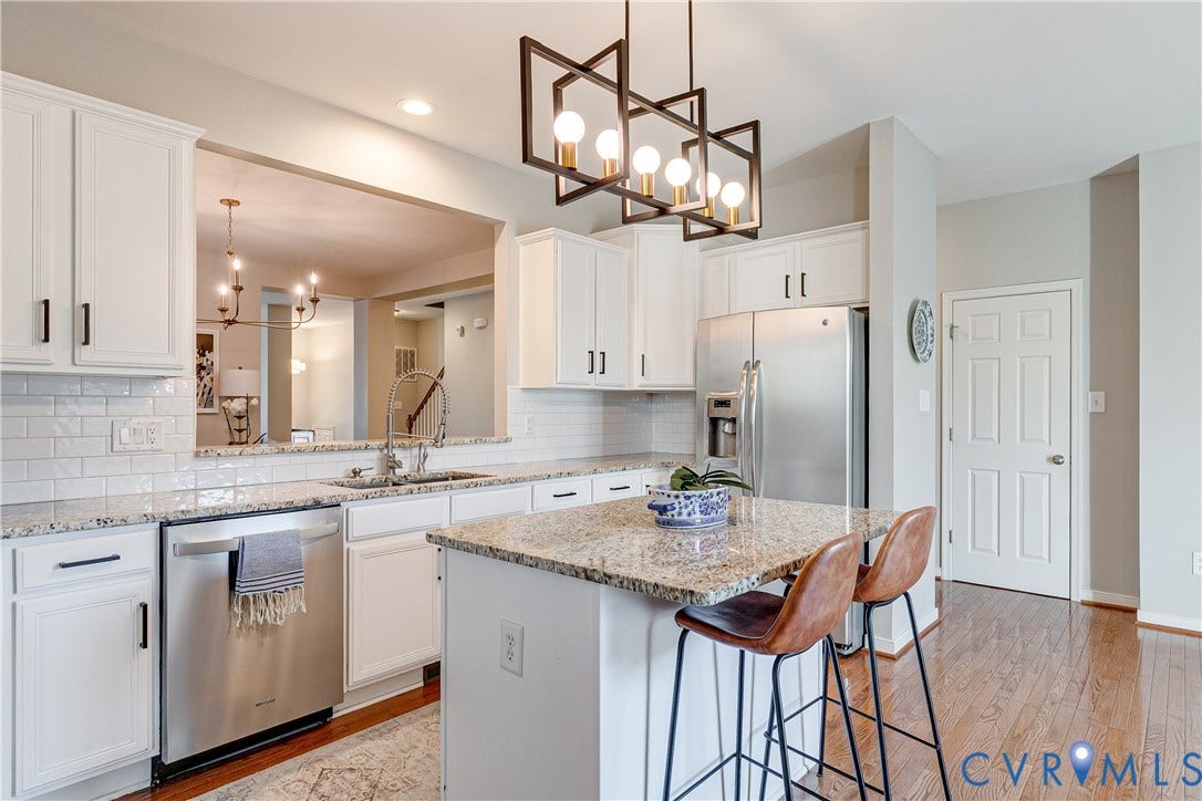 1733 W Cary Street, Richmond, VA 23220 White cabinetry, stainless steel appliances, granite countertops, and wood-finish flooring