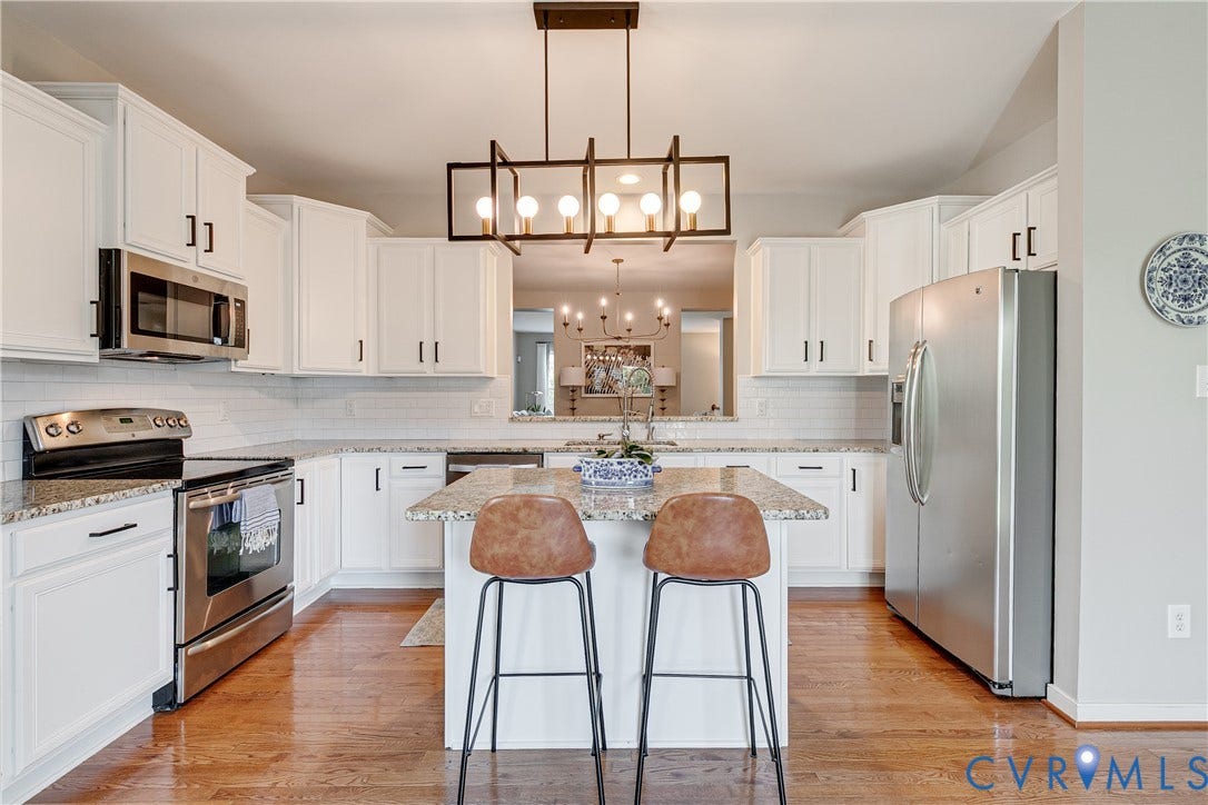 1733 W Cary Street, Richmond, VA 23220 Kitchen featuring white cabinetry, stainless steel appliances, granite countertops, and wood-finish flooring