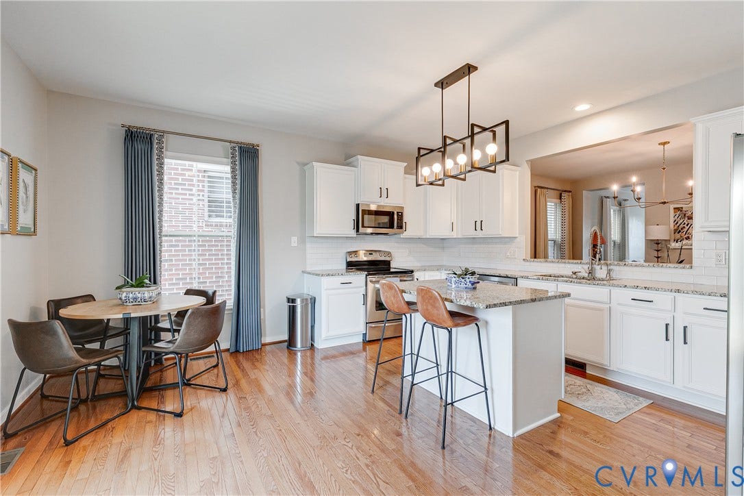 1733 W Cary Street, Richmond, VA 23220 Hardwood flooring, white cabinetry, stainless steel appliances, and granite countertops