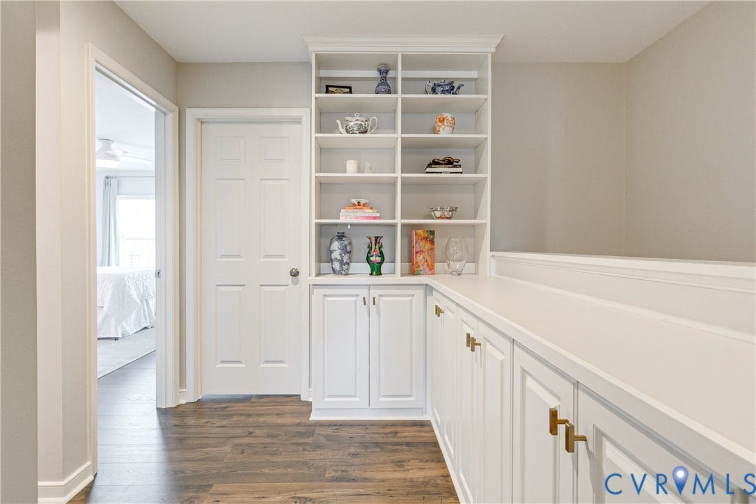 1733 W Cary Street, Richmond, VA 23220 Built-in shelving, white cabinetry, long countertop surface, and wood-finish flooring