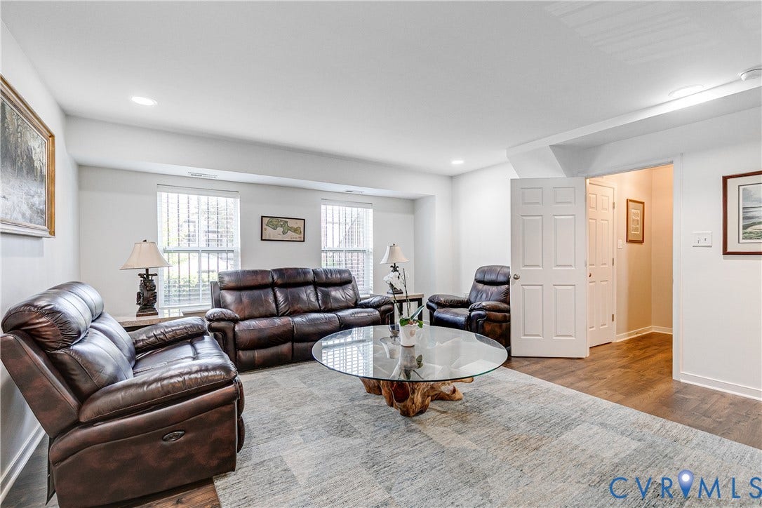 1733 W Cary Street, Richmond, VA 23220 Wood-finish flooring, white paneled doors, and multiple windows