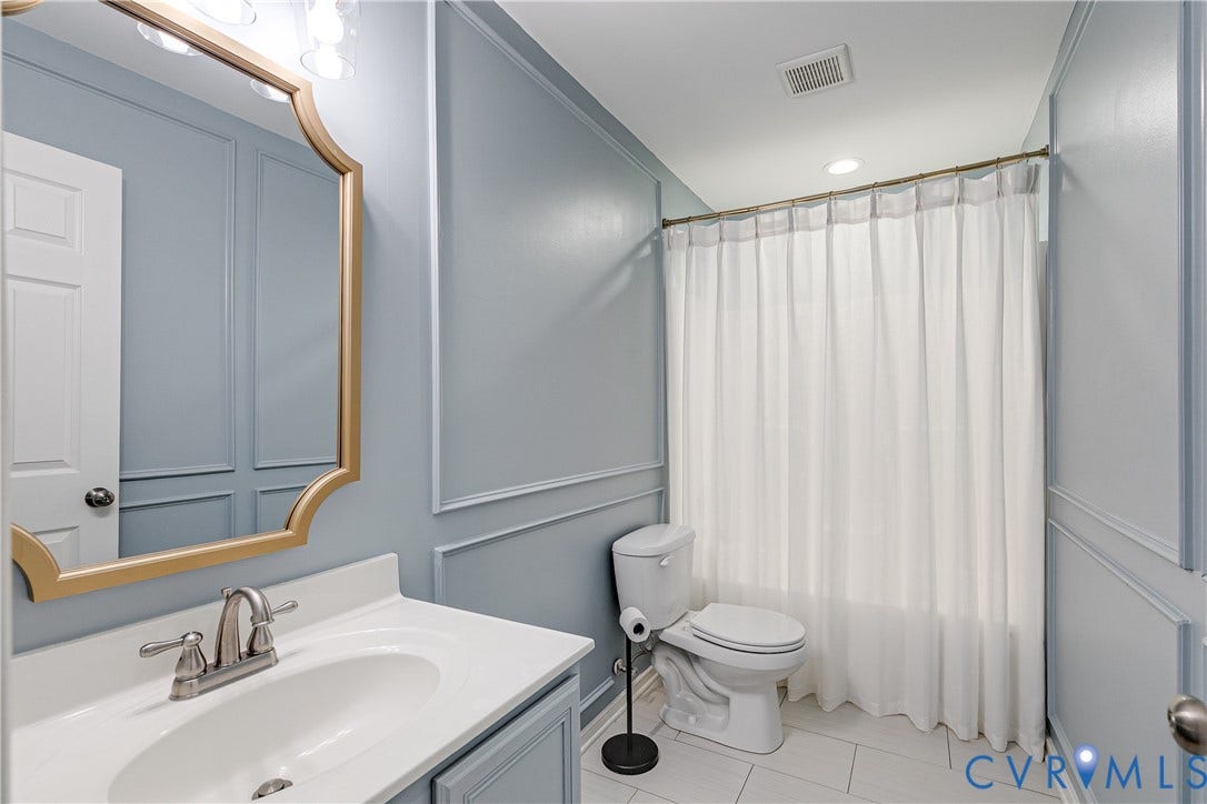 1733 W Cary Street, Richmond, VA 23220 Decorative wall paneling, vanity with sink, and tiled flooring