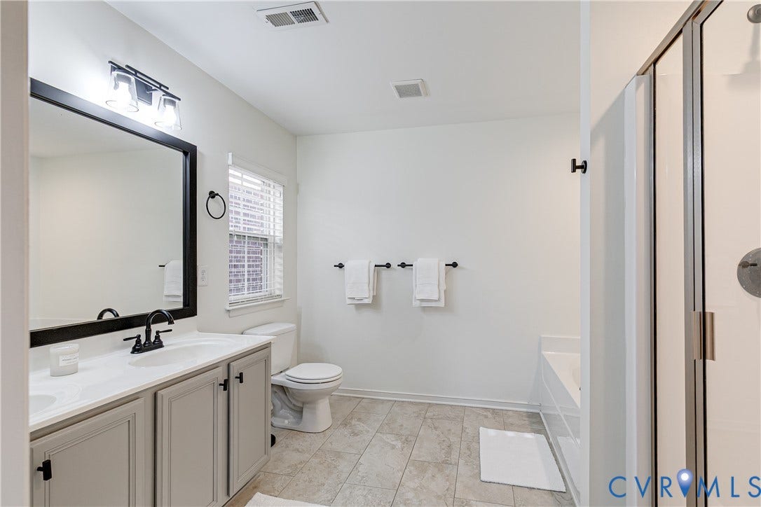 1733 W Cary Street, Richmond, VA 23220 Bathroom featuring a vanity with light-colored cabinetry, and a shower with a clear glass enclosure