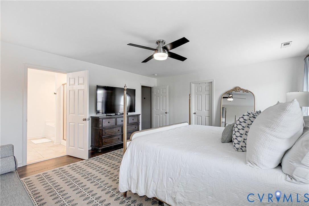 1733 W Cary Street, Richmond, VA 23220 Spacious primary bedroom bedroom with wood-finish flooring, ceiling fan, and white walls