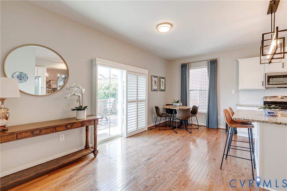 1733 W Cary Street, Richmond, VA 23220 Hardwood flooring, sliding glass door with louvered shutters, recessed kitchen lighting, and granite countertop