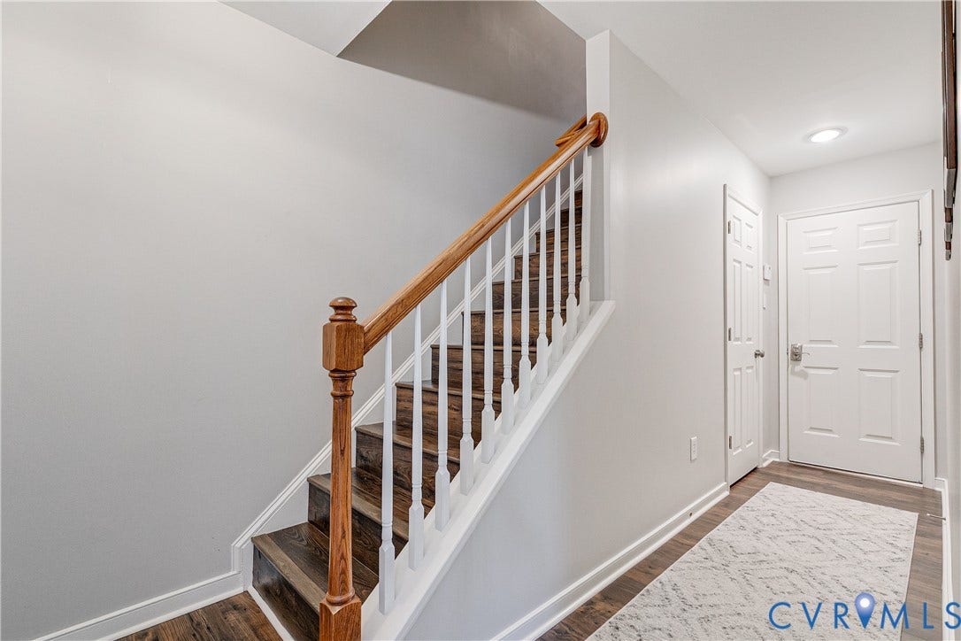 1733 W Cary Street, Richmond, VA 23220 Staircase featuring wood-finish treads, a wood handrail, and white balusters
