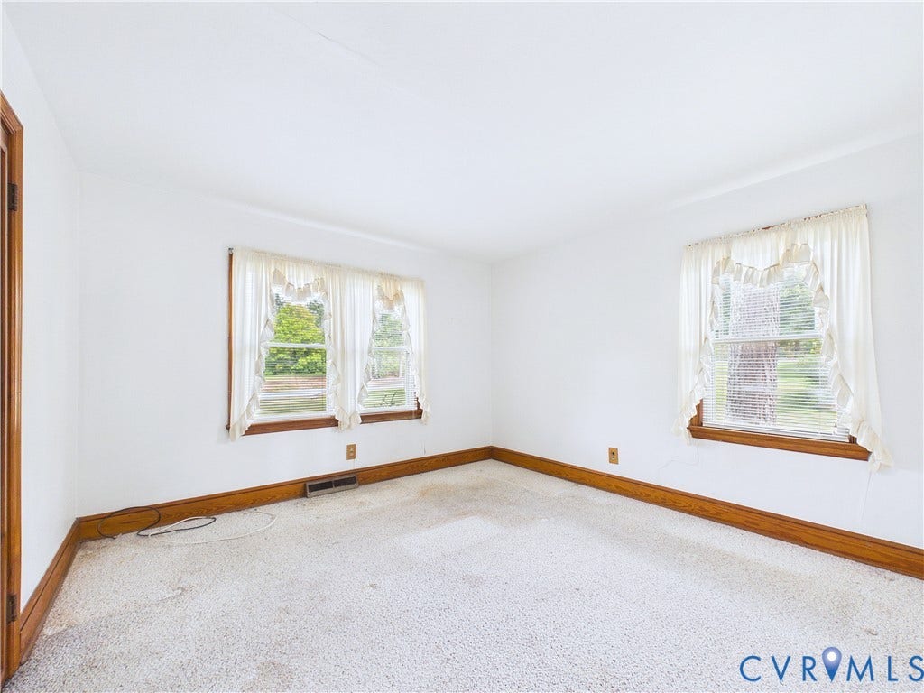 Light-colored carpeting with wood-finish trim