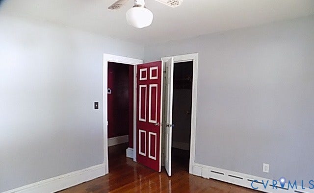 212 Royal Oak Avenue, Riverside Park, Colonial Heights, VA 23834 Hardwood flooring with a polished finish, white baseboards, and a paneled interior door with white trim