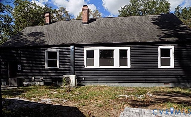 212 Royal Oak Avenue, Riverside Park, Colonial Heights, VA 23834 Black horizontal siding exterior with a dark shingle roof, two brick chimneys, and white-framed windows