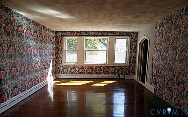 212 Royal Oak Avenue, Riverside Park, Colonial Heights, VA 23834 Hardwood flooring, triple window arrangement, decorative wallpaper, white trim, and arched doorway