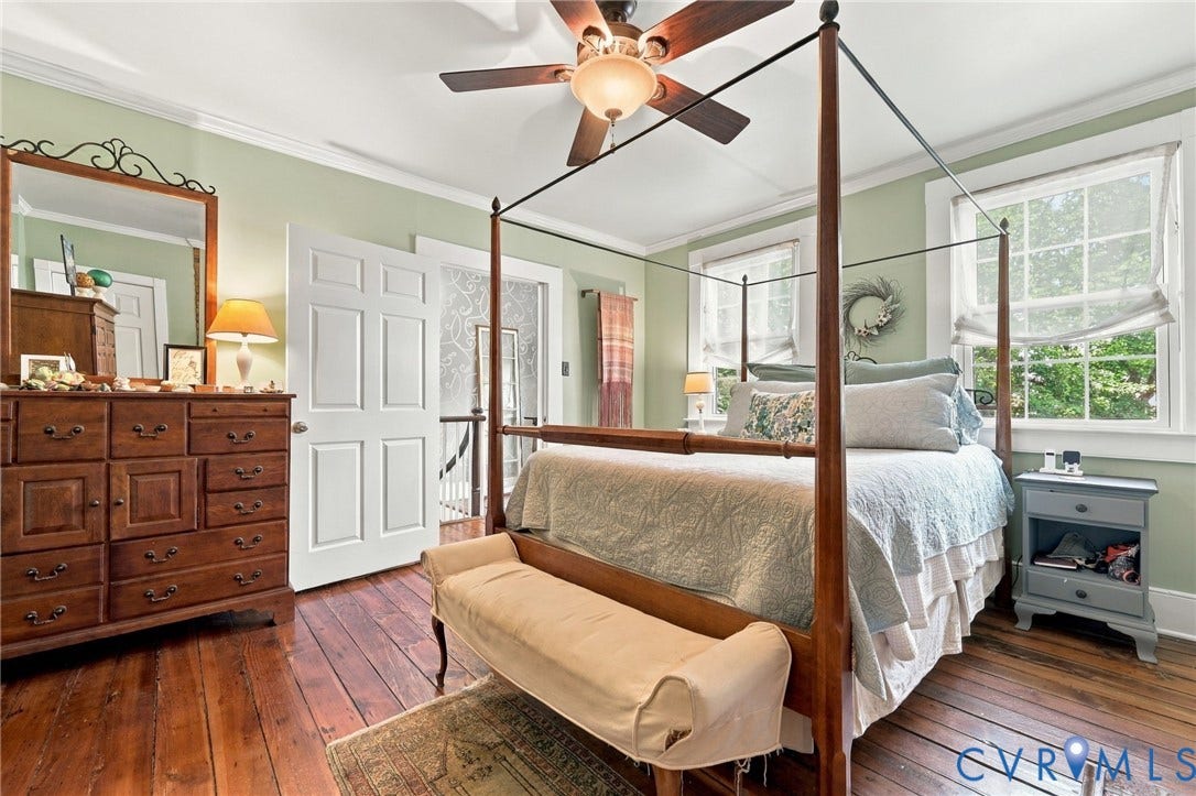 Hardwood flooring throughout, crown molding, two windows with natural light, and a ceiling fan with integrated lighting