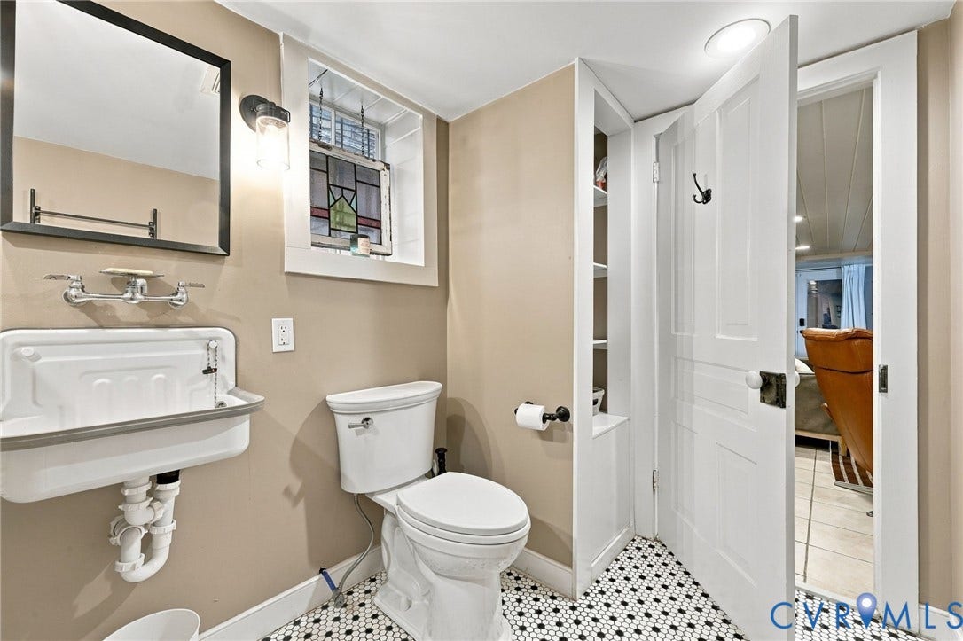 Basement bathroom with black and white hexagonal floor tiling