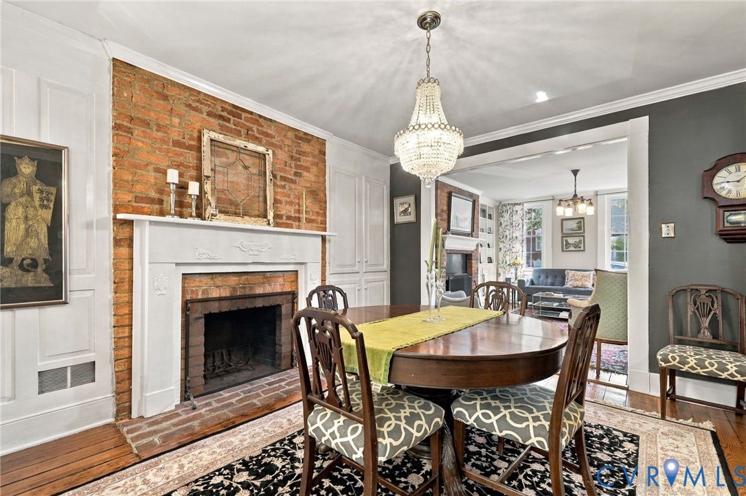 Exposed brick fireplace with a classic white mantel