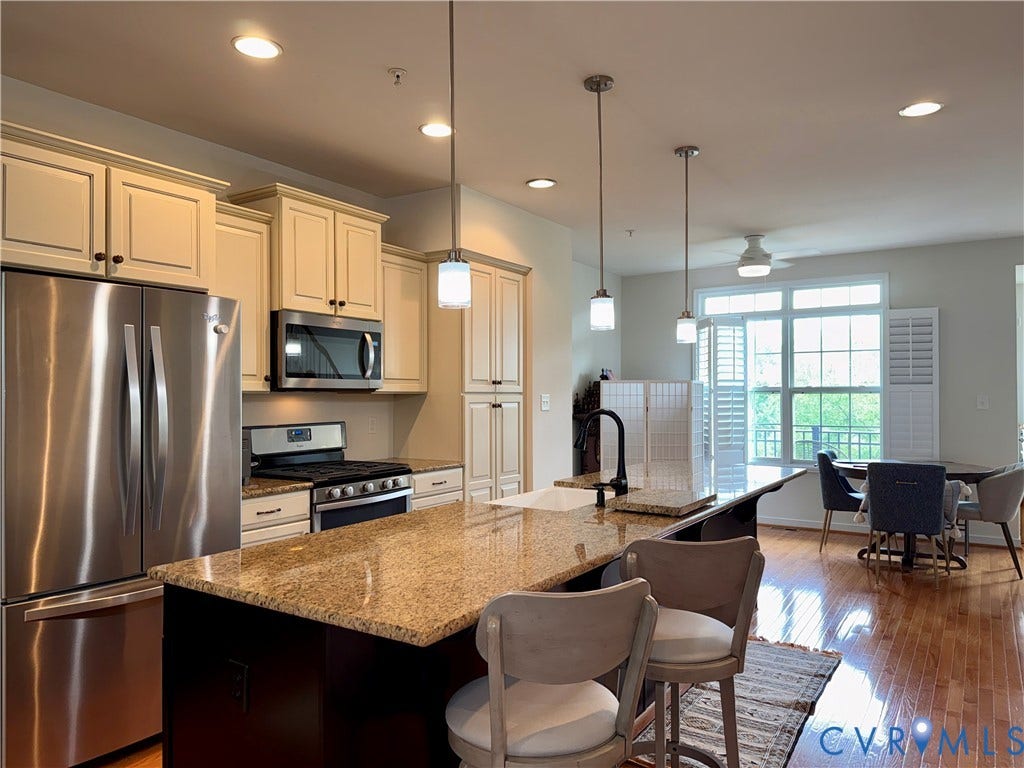 3931 Liesfeld Place, West Broad Village, Henrico, VA 23060 Kitchen featuring a large central island with granite countertop, stainless steel appliances, recessed lighting, and wood-finish flooring