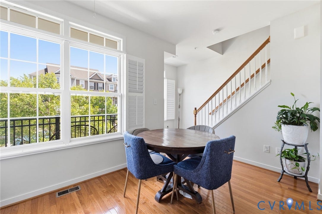 3931 Liesfeld Place, West Broad Village, Henrico, VA 23060 Hardwood-style flooring throughout, large windows with white louvered shutters, and a staircase with a wood-finish handrail and white balusters