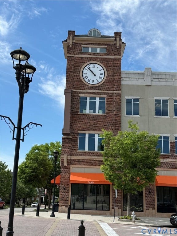 3931 Liesfeld Place, West Broad Village, Henrico, VA 23060 Brick faade clock tower building with multiple windows, street lamps, and sidewalk paving