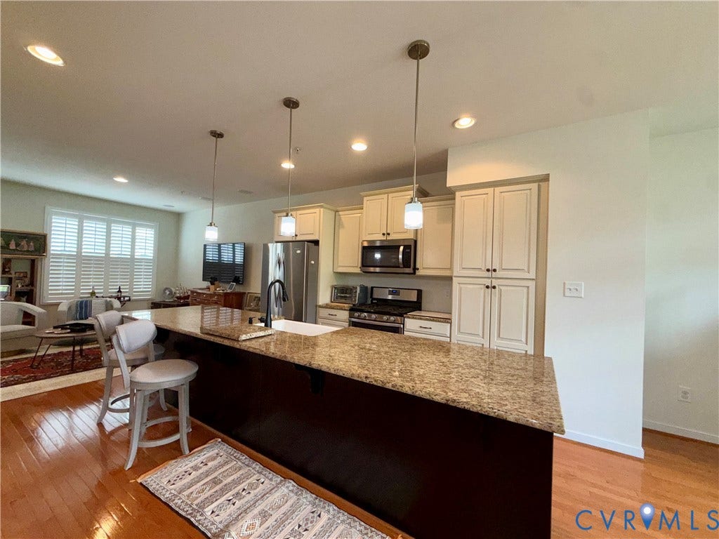 3931 Liesfeld Place, West Broad Village, Henrico, VA 23060 Open-concept kitchen featuring an expansive island with a granite countertop, white shaker cabinetry, stainless steel appliances, and recessed lighting