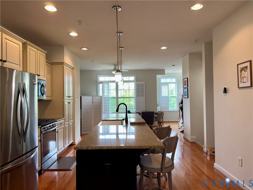 3931 Liesfeld Place, West Broad Village, Henrico, VA 23060 Chef's kitchen showcasing stainless steel appliances, custom cabinetry with soft-close doors, and a large center island with seating