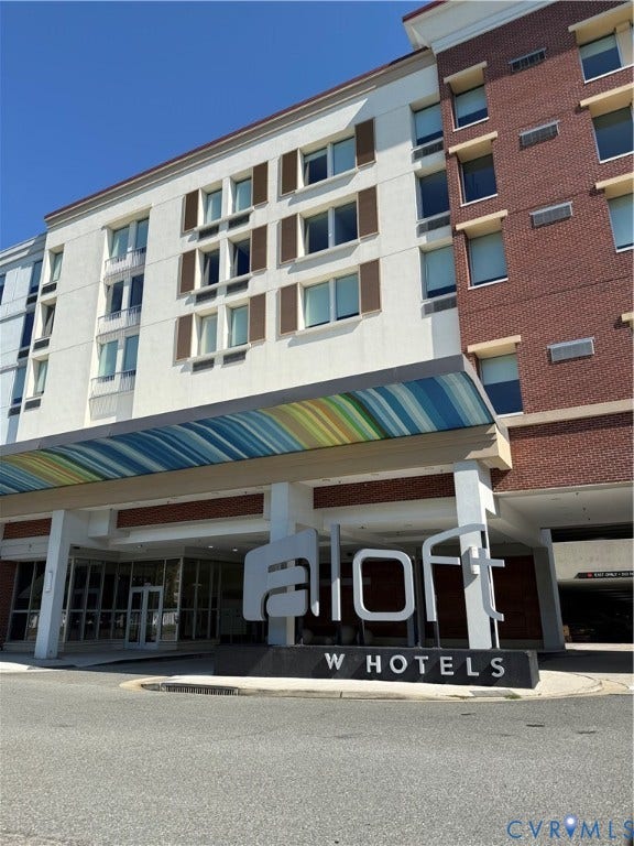 3931 Liesfeld Place, West Broad Village, Henrico, VA 23060 Multi-story commercial building featuring a white facade with brown shutters, a brick facade, and a prominent brand signage