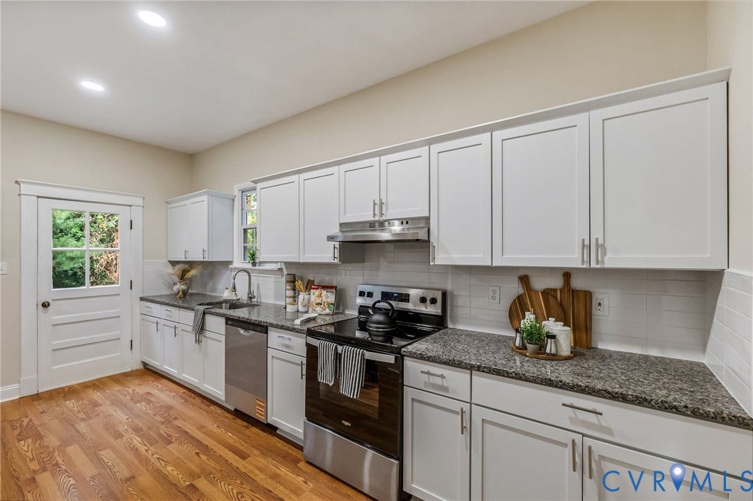 12105 Mathenay Drive, Mathenay, Chesterfield, VA 23831 Kitchen featuring wood-finish flooring, white cabinetry with silver-tone hardware, stainless steel appliances, granite countertops, and a subway tile backsplash