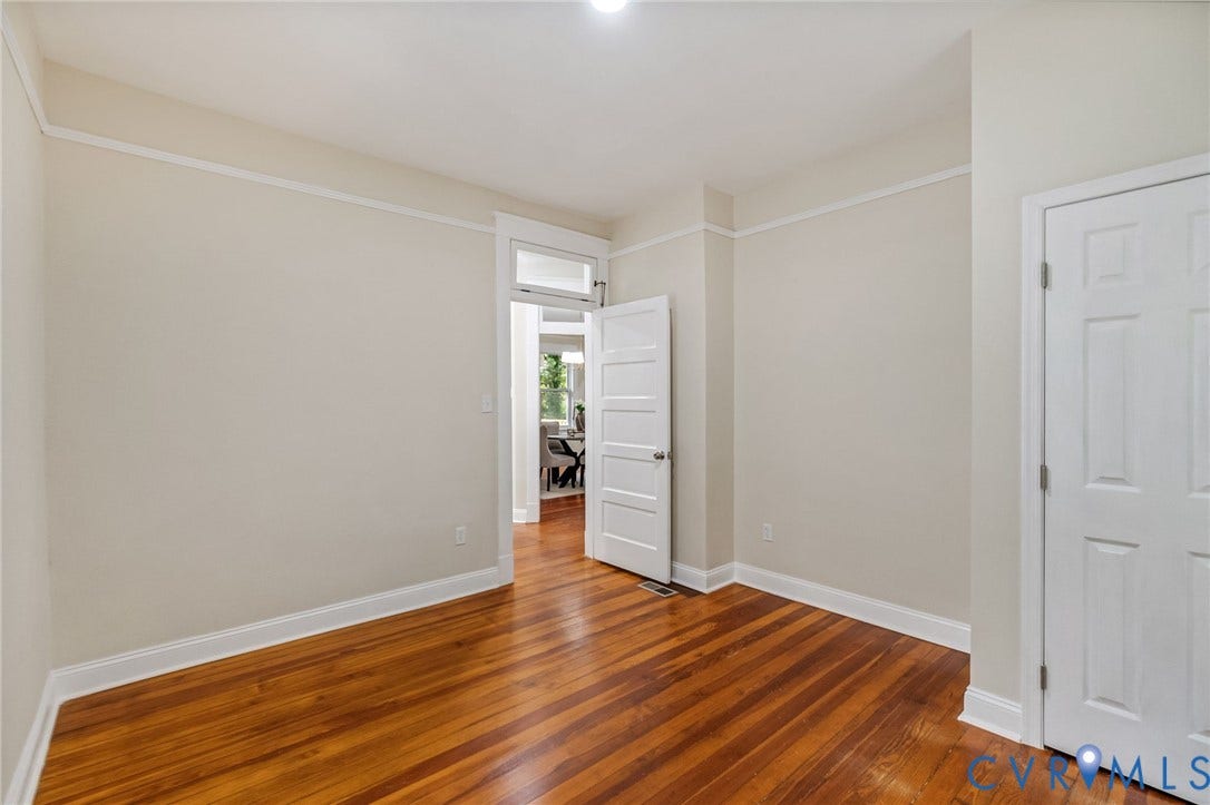 12105 Mathenay Drive, Mathenay, Chesterfield, VA 23831 Wood-finish flooring, white trim, solid paneled doors, and a transom window above an interior doorway