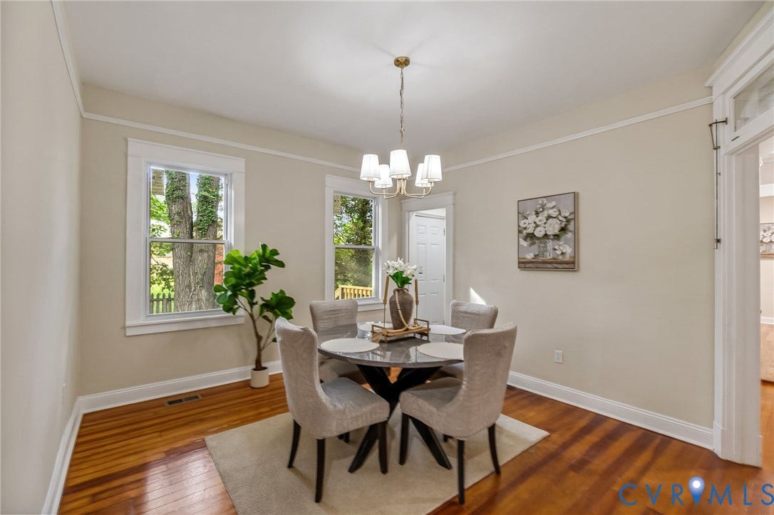 12105 Mathenay Drive, Mathenay, Chesterfield, VA 23831 Hardwood flooring, white trim, two windows, crown molding, and a brass chandelier