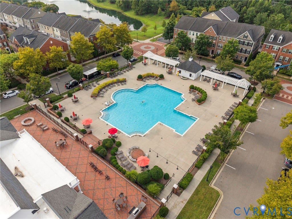 Expansive outdoor pool with integrated spa and surrounding lounge areas