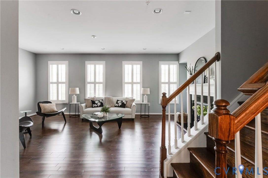 Hardwood-finish flooring, recessed lighting, and multiple windows with plantation shutters