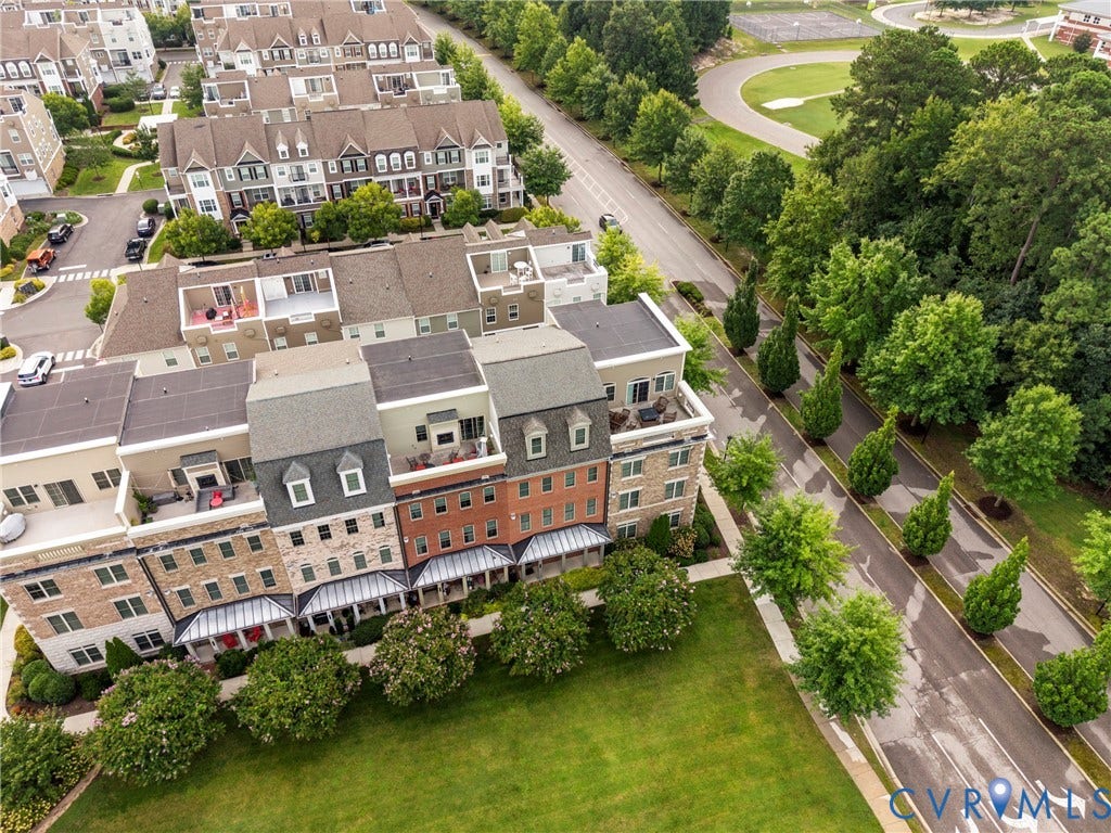 Multi-level townhomes featuring rooftop terraces, private balconies, and dormer windows