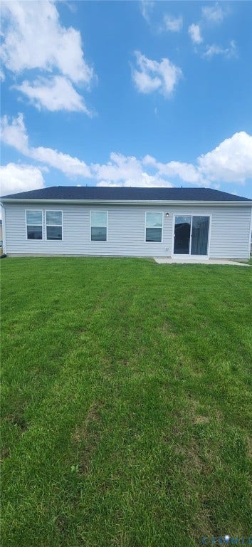 321 Camerons Ferry Drive, Glen Allen, VA 23060 Expansive green lawn with a gray siding exterior, multiple windows, and a glass sliding door opening to a concrete patio