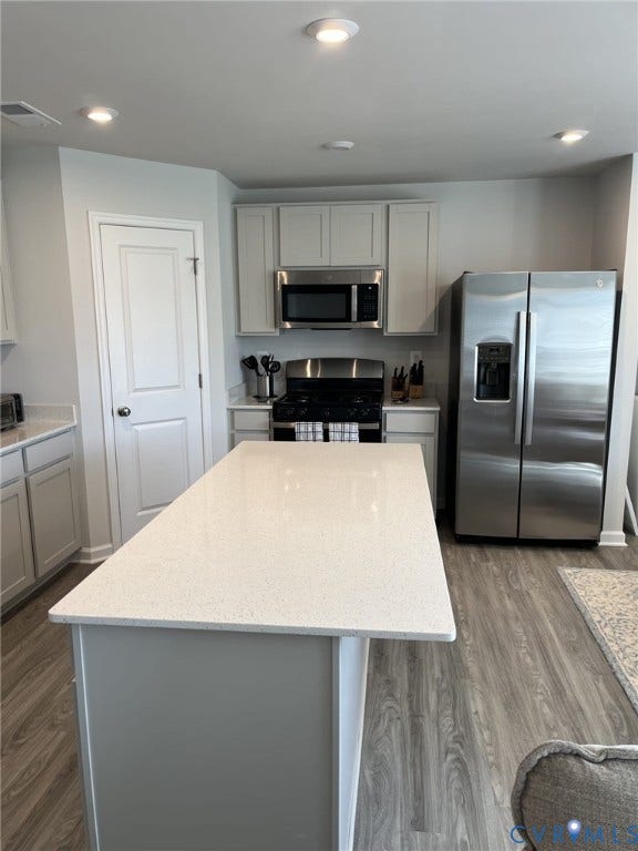 321 Camerons Ferry Drive, Glen Allen, VA 23060 Kitchen featuring a central island with a light-toned countertop, stainless steel appliances, recessed ceiling lighting, and wood-finish flooring