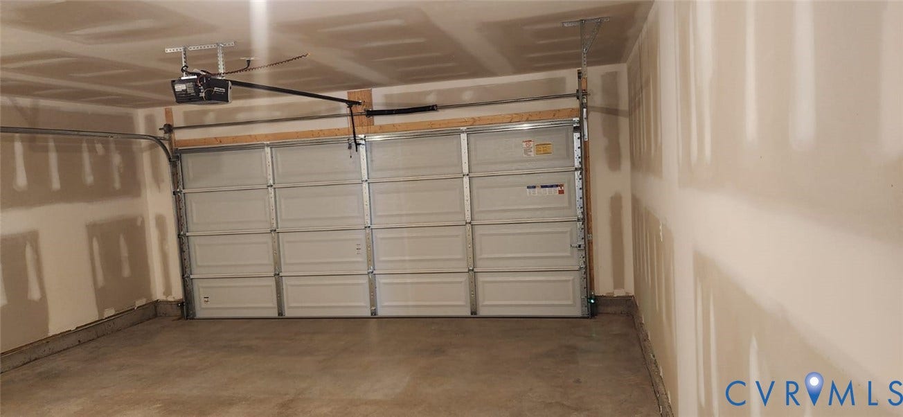 321 Camerons Ferry Drive, Glen Allen, VA 23060 Two-car garage with a panel garage door, concrete flooring, and an automatic garage door opener