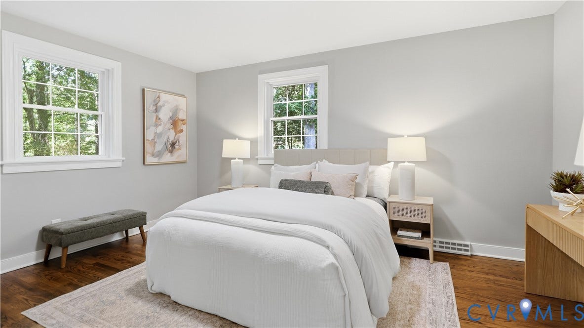 Hardwood flooring throughout, bright white trim, and light gray wall color