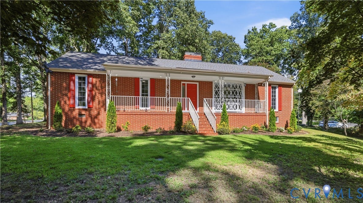 Brick exterior with a covered front porch featuring white railings